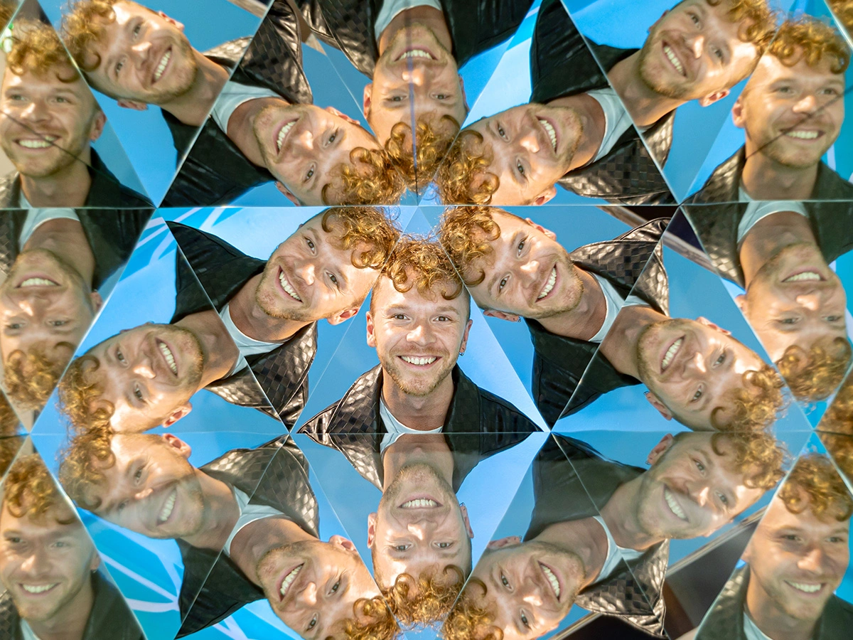 A young man's face is multiplied through the Kaleidoscope at Museum of Illusions Manchester.