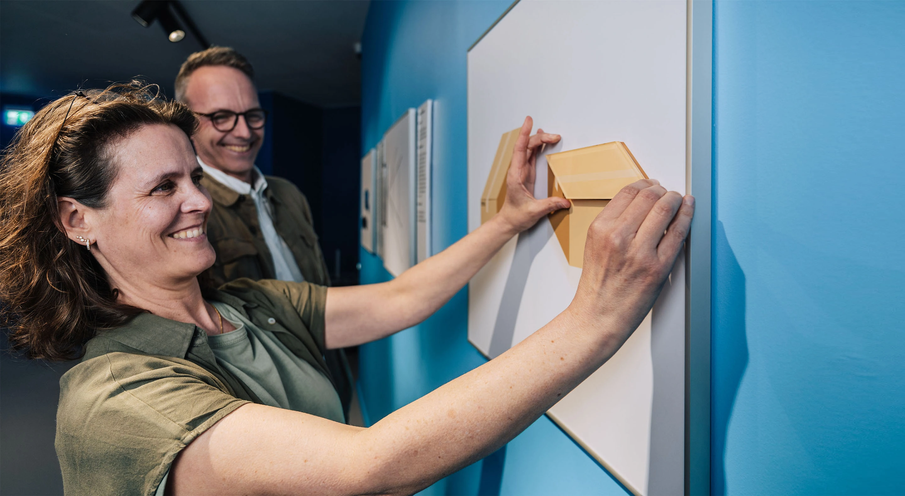 Visitors are interacting with the Shepard's Boxes illusion.