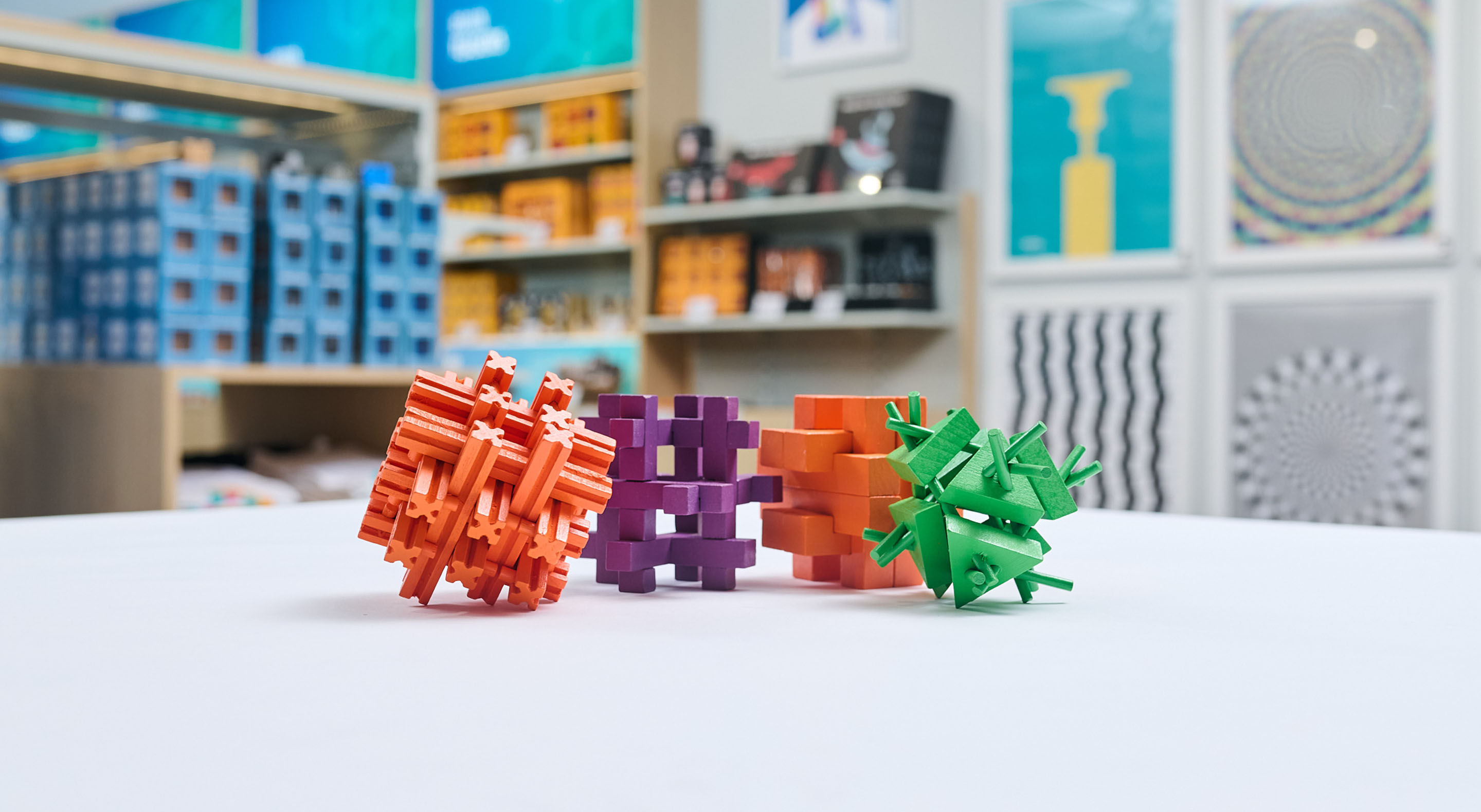 Colorful wooden cube puzzles at a display in the Museum of Illusions' shop.
