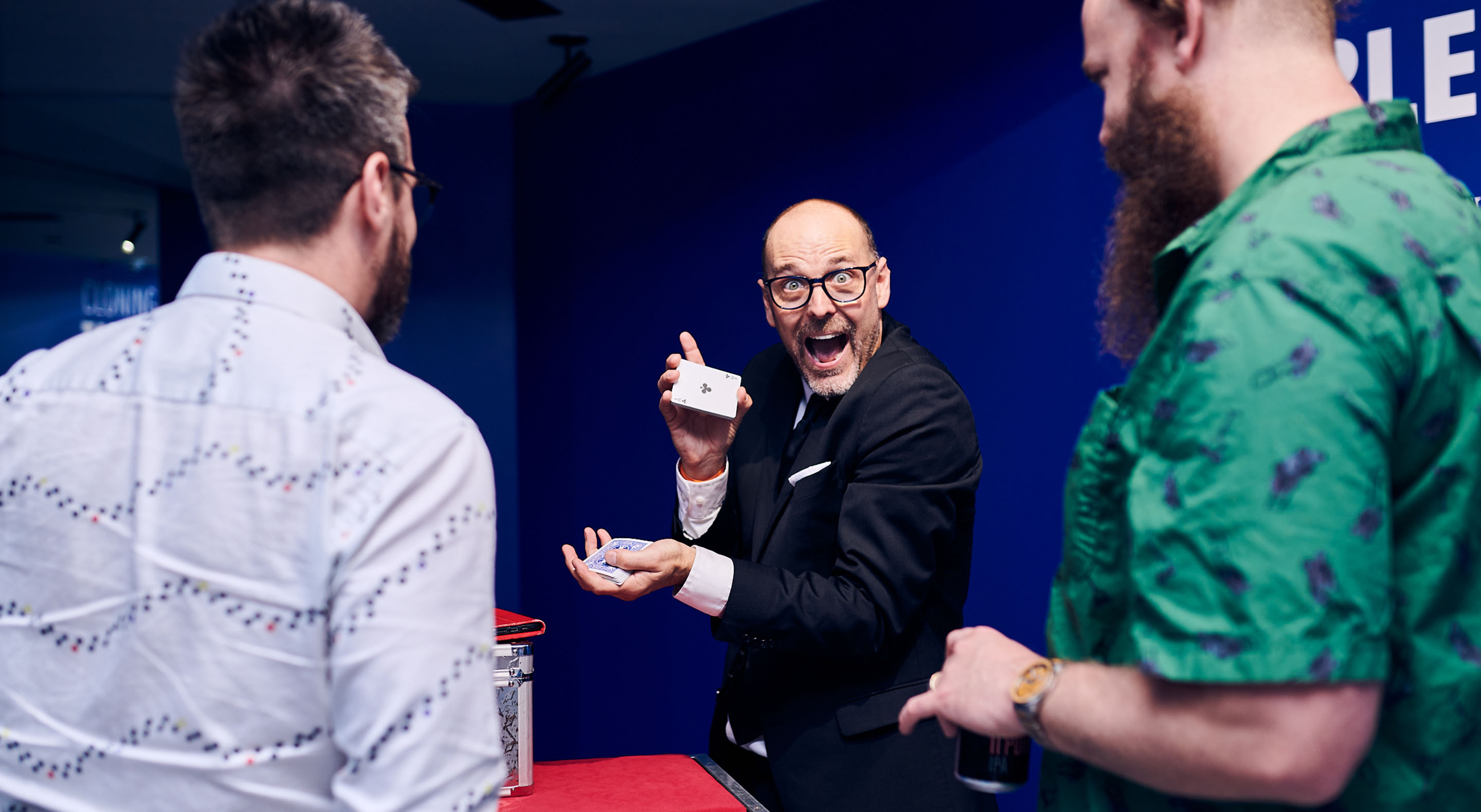 A magician is performing at an event at Museum of Illusions.