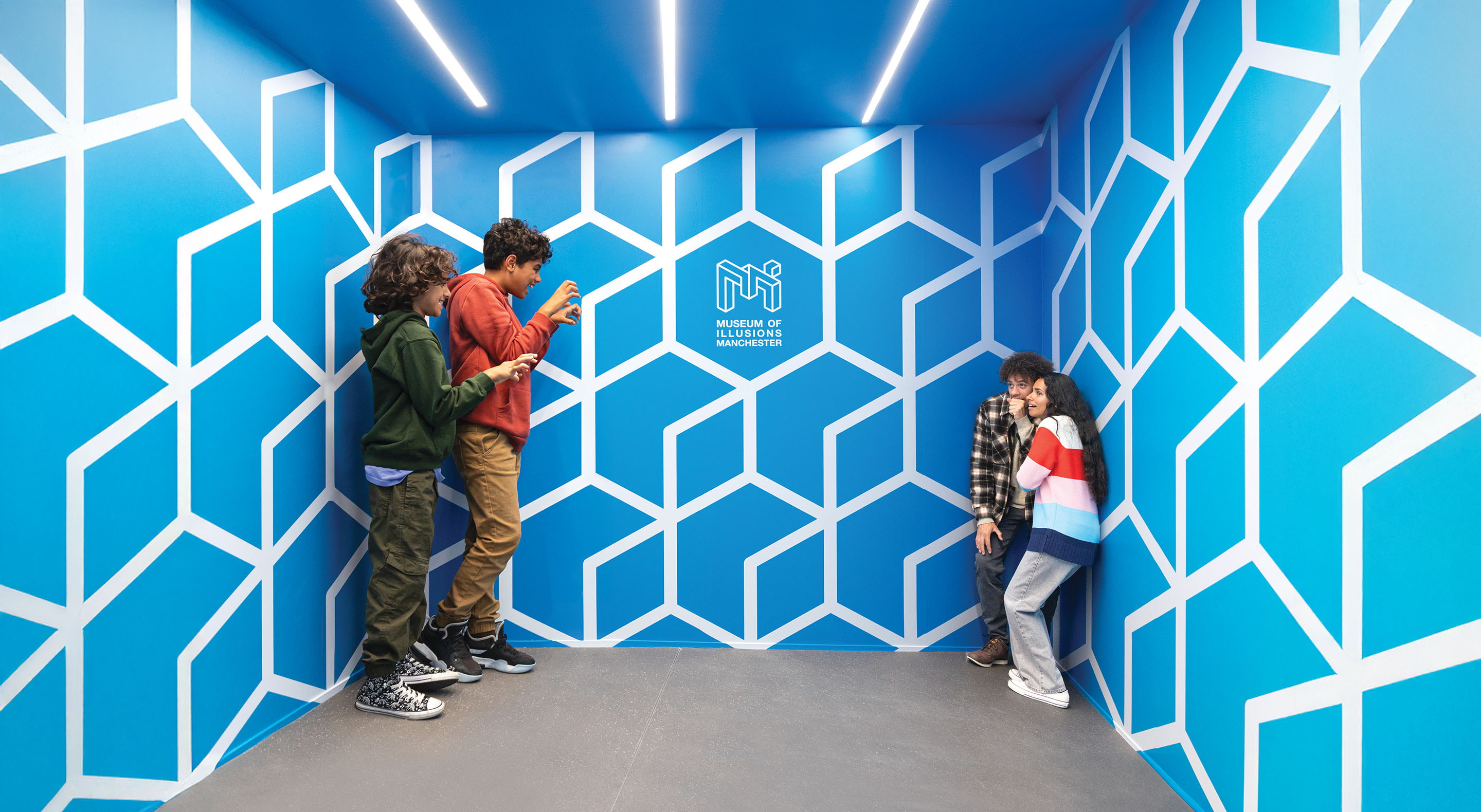 Children standing in one corner of the Ames Room look much bigger than their parents standing in the other corner.