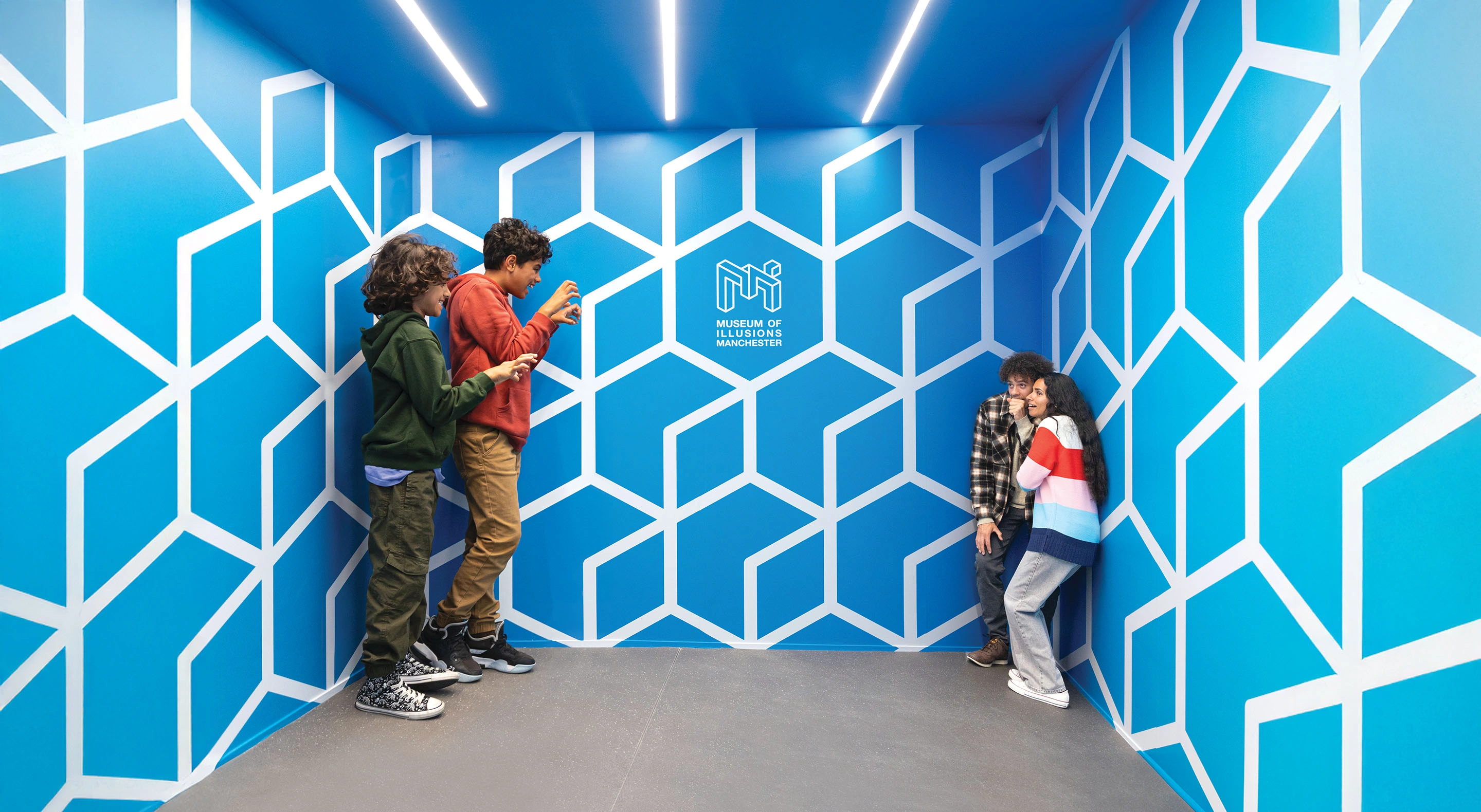 Children standing in one corner of the Ames Room look much bigger than their parents standing in the other corner.