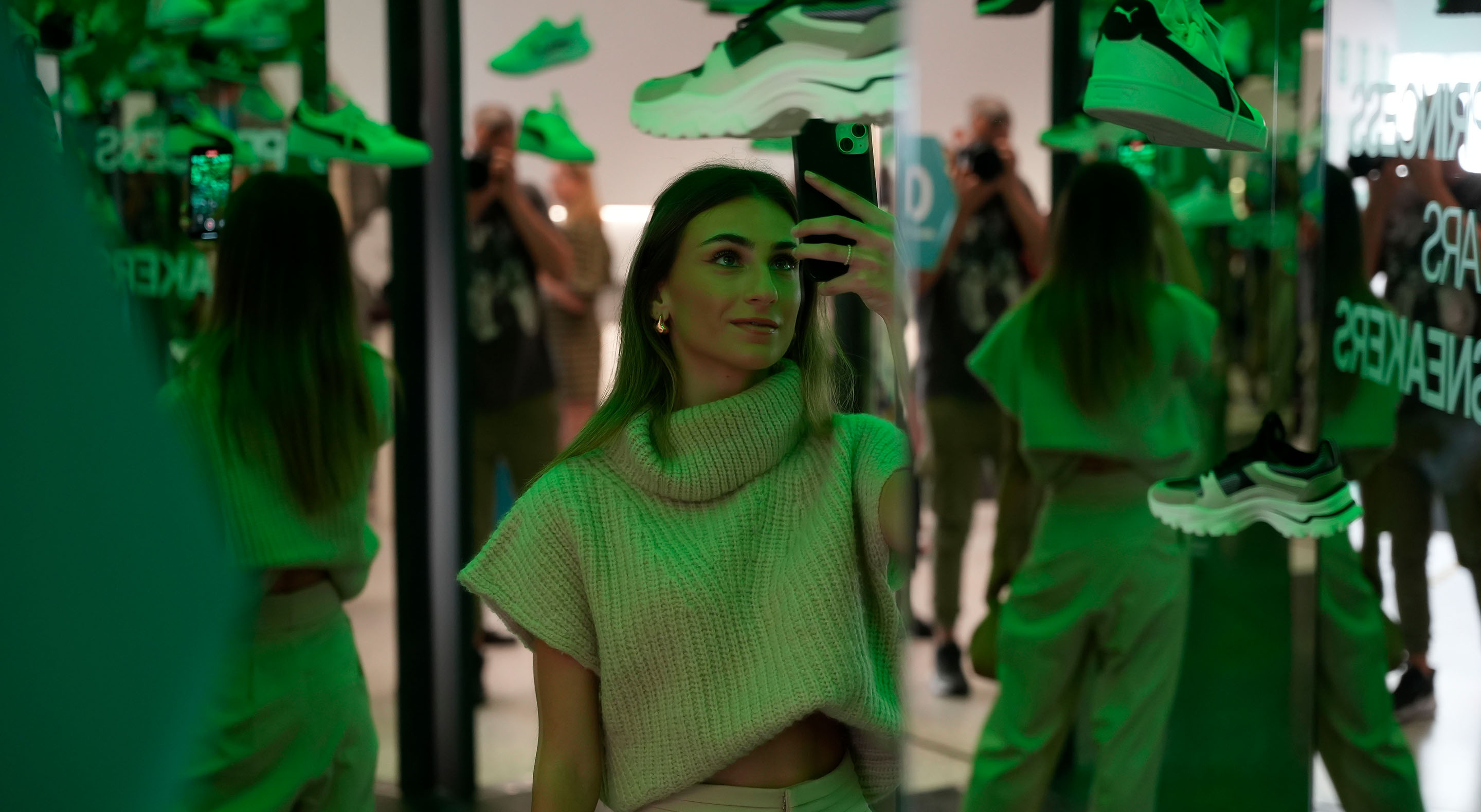 A young woman is taking a photo at the sports shoe launch event at Museum of Illusions.