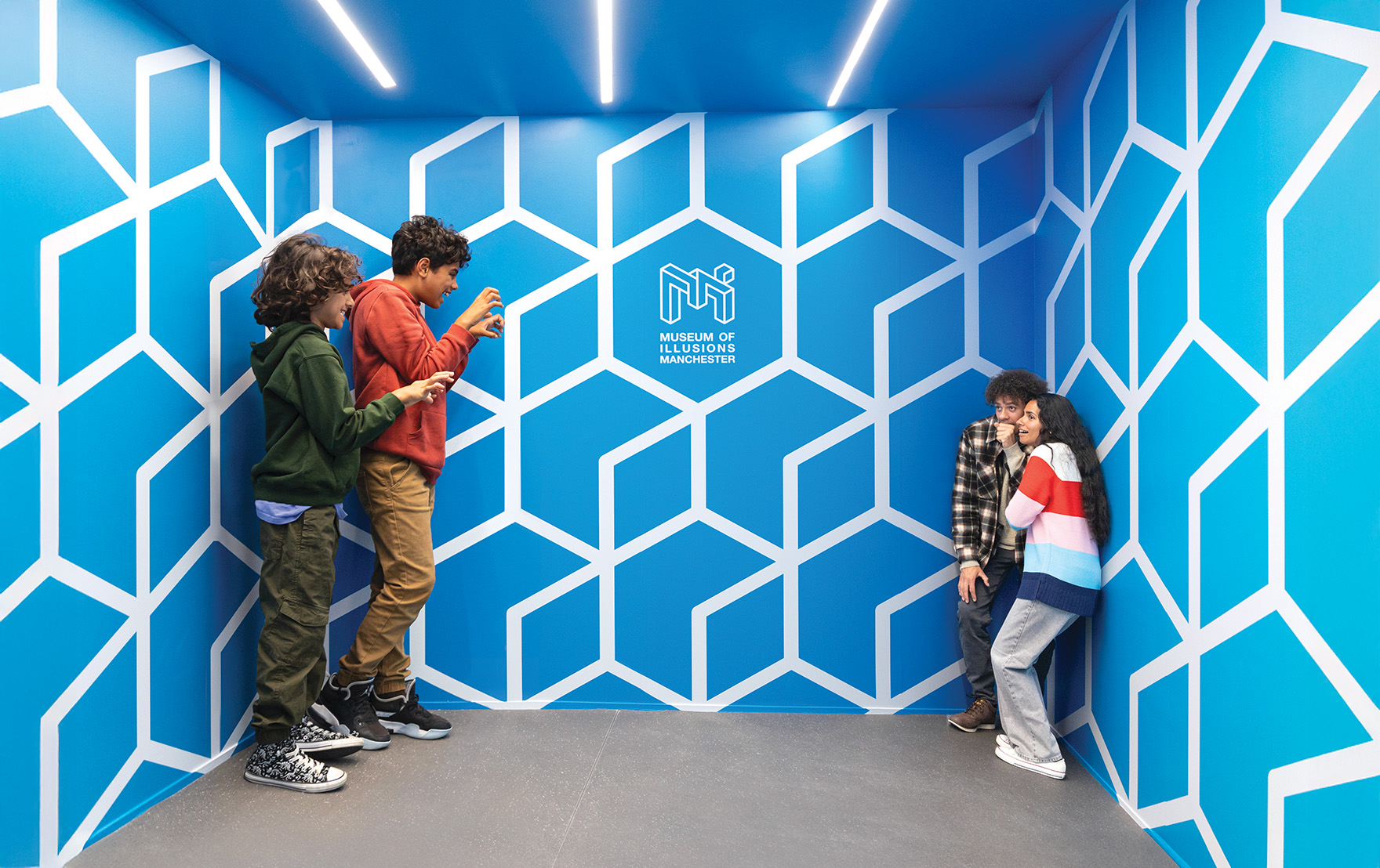 Visitors in one corner of the Ames Room look much larger than those standing in the opposite corner.
